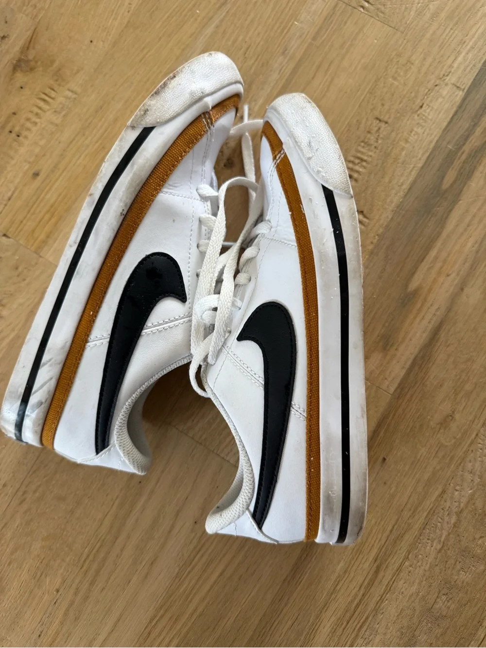 Nike Kids White Sneakers with Black Swoosh and Brown Trim